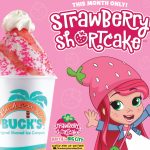 Promotional graphic for a Bahama Buck's and Strawberry Shortcake collaboration. The ad features the cartoon character Strawberry Shortcake next to a themed 'Strawberry Shortcake' shaved ice, which is available 'This Month Only!'. The shaved ice is topped with pink sprinkles and whipped cream.