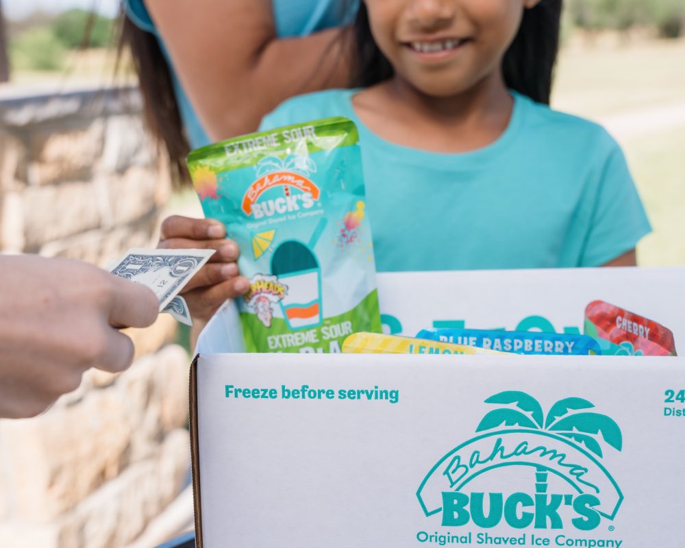 Young girl selling SnoBlast at an event.