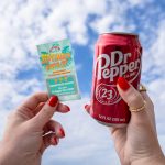 A pair of hands holds up two items against a blue sky: a can of Dr Pepper and a Bahama Buck's 'September Scratch-Offs' ticket revealing a 'GRAND PRIZE WINNER!' message for 'Dr Pepper for a Year!'.