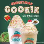 Promotional graphic for the seasonal 'Christmas Cookie Sno & Smoothie' from Bahama Buck's. The ad features a shaved ice and a smoothie, both decorated with festive red and green sprinkles. A logo notes the treats are 'made with Blue Bell Ice Cream'.